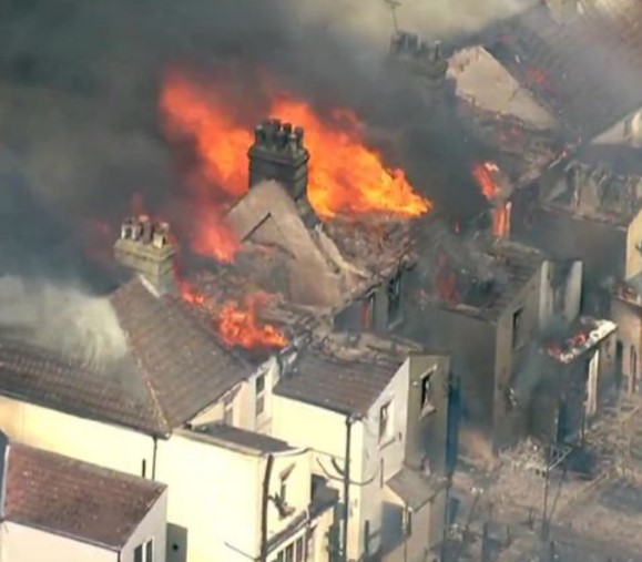 Aerial view of houses on fire during the July 2022 UK heatwave.